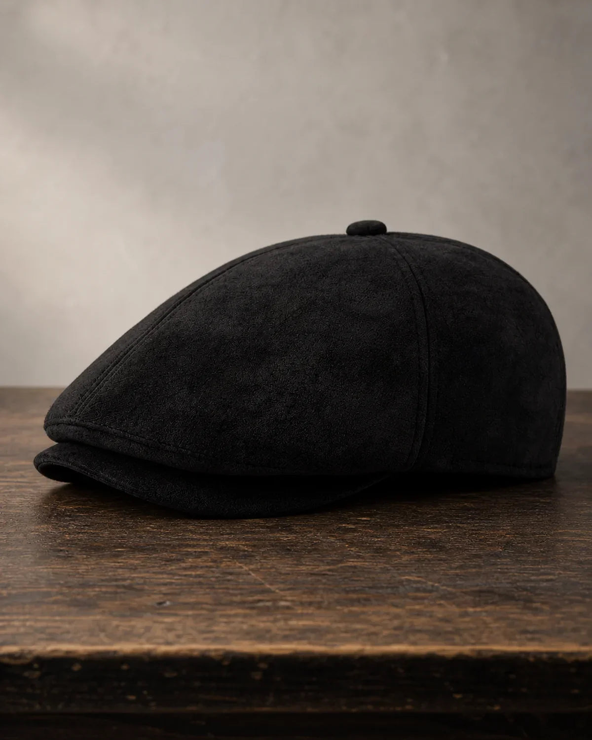 Boina Masculina Inglesa Couro Vegan Black sobre mesa de madeira escura Cappel