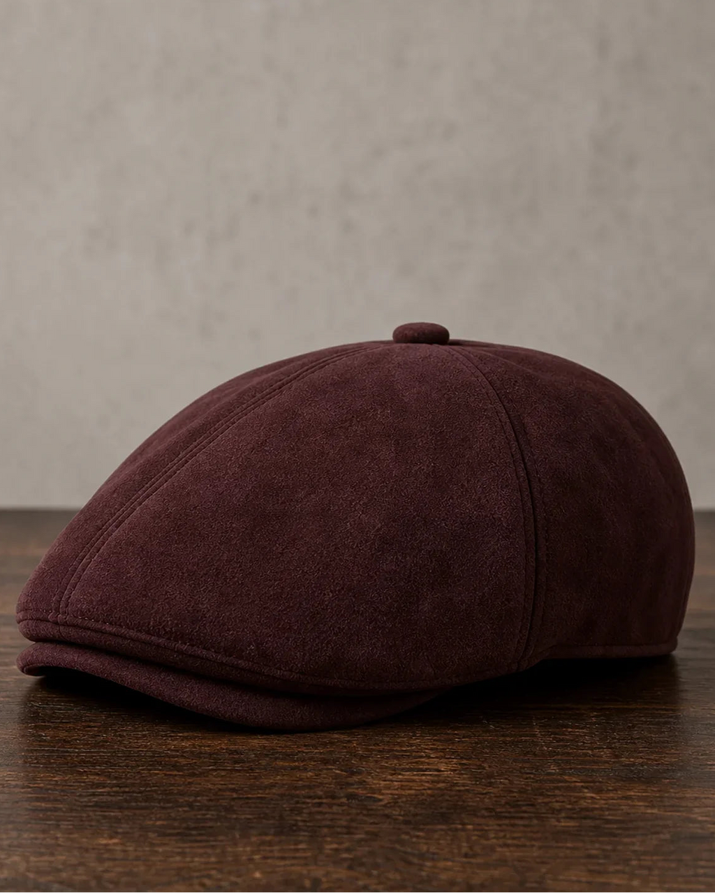 Boina Masculina Inglesa Couro Vegan Burgundy sobre mesa de madeira escura Cappel