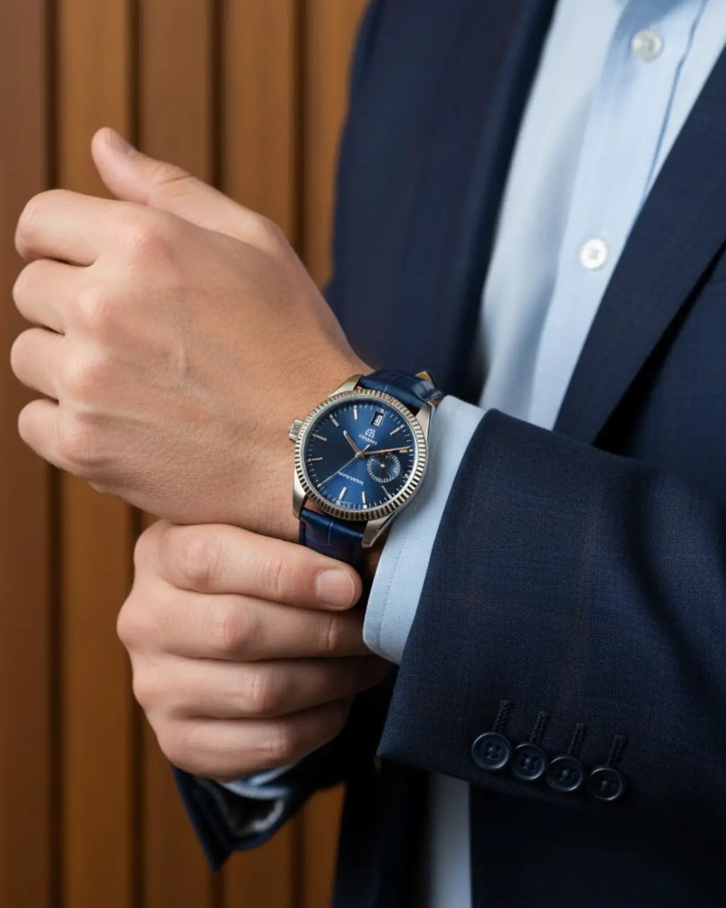 Homem ajustando o Relógio Masculino Pulseira de Couro Regent Blue com traje social azul
